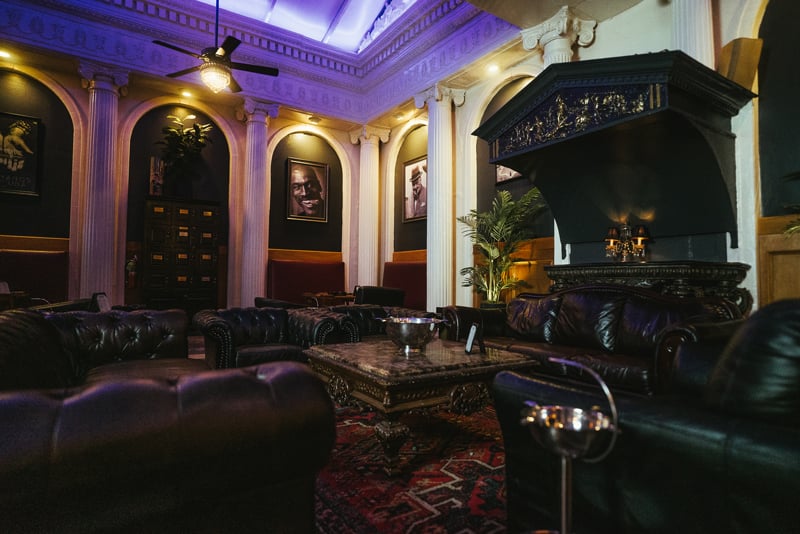 The marble atrium back room at Cuban Creations, with high vaulted ceilings, columns and leather seating